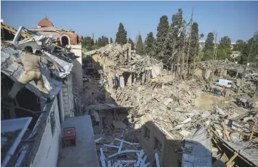  ?? Associated Press ?? Fighting between Armenia and Azerbaijan has destroyed homes like these in Ganja, Azerbaijan.