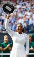  ?? MICHAEL STEELE/ GETTY IMAGES ?? Serena Williams smiles as she lifts the runnerup trophy after losing 6-3, 6-3 to Angelique Kerber on Saturday in the Wimbledon final in London. After the match, her voice broke as she said: “To all the moms out there, I was playing for you today. And I...