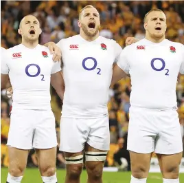  ??  ?? Loud and proud: Brown, Haskell and Hill sing the National Anthem