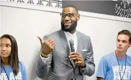  ??  ?? A file photo of LeBron James addressing students at the opening of a public school in Akron, Ohio.