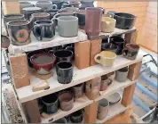  ?? Photos by John Popham ?? LEFT: The shelves of the gas kiln outside of the Moon Building are full of mugs that will be sold Friday to benefit The Ruth and Naomi Project. Note that some of these items such as bowls and vases are student projects and will not be for sale.