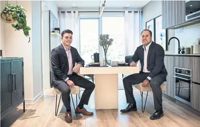  ?? NICK KOZAK FOR THE TORONTO STAR ?? John-David Du Vernet, left, with Line 5 Condos Reserve Properties COO Shane Fenton in the kitchen of a model suite.