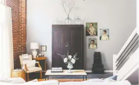  ??  ?? A vintage wardrobe from the 1800s serves as a focal point and adds storage in this Florence, Ala., living room featured in Leggett’s book City Farmhouse Style.