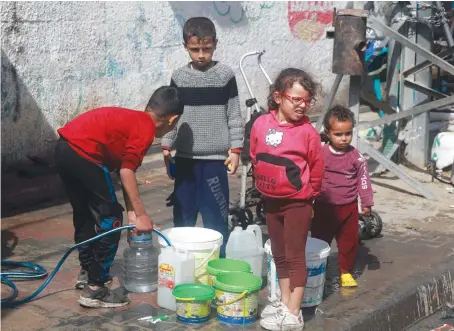  ?? AFP ?? Palestinia­n children fetch water in Rafah in the southern Gaza Strip on Saturday amid the ongoing conflict between Israel and Hamas.