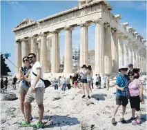  ?? MILOS BICANSKI/GETTY IMAGES ?? Tourists visit the ancient Acropolis of Athens on Wednesday. “Ensure that you have enough cash to cover unexpected travel expenses,” Ottawa says in a tourist advisory this week.