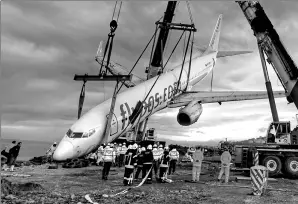  ?? TURKAY ALBAYAK / ASSOCIATED PRESS ?? A crane lifts a Boeing 737-800 of Turkey’s Pegasus Airlines, from a slope in Trabzon, Turkey, on Thursday.