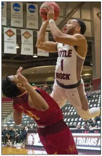  ?? (Photo courtesy UALR Athletics) ?? UALR’s Markquis Nowell (right) puts up a shot Friday over a Louisiana-Monroe defender during the Trojans’ 66-62 victory over the Warhawks at the Jack Stephens Center in Little Rock. Nowell finished with 17 points.