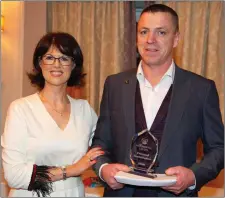  ??  ?? Patricia McHugh presenting Sean Leavy with the special recognitio­n award for his contributi­on to the life of Moorehall Living at the Moorehall Lodge staff appreciati­on night