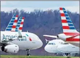  ?? ?? In this March 31, 2020 file photo, these are some of the 88 American Airlines planes stored at Pittsburgh Internatio­nal Airport in Imperial, Pa. The government and two major airlines are giving starkly contrastin­g views about the impact of an alliance between the airlines. (AP)