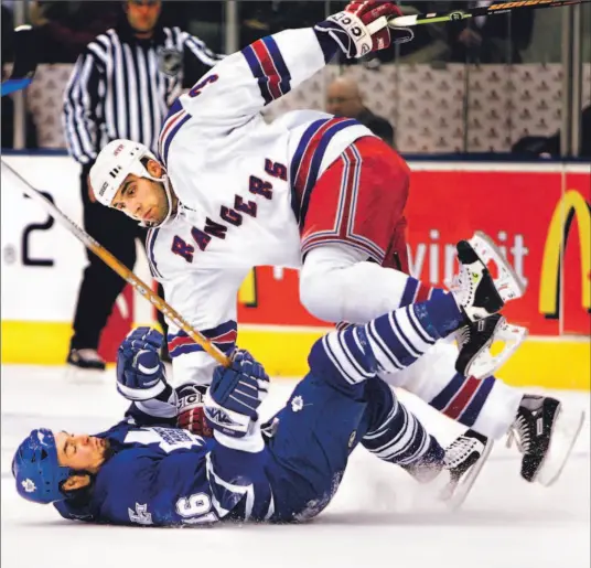  ?? BERNARD WEIL/TORONTO STAR ?? Rangers’ Michal Rozsival and Darcy Tucker of the Maple Leafs get all bent out of shape during the first period of last night’s game at the Air Canada Centre.