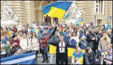  ?? AFP ?? Residents of Kherson temporaril­y living in Odesa, holding Ukrainian flags, celebrate the liberation of their native town.