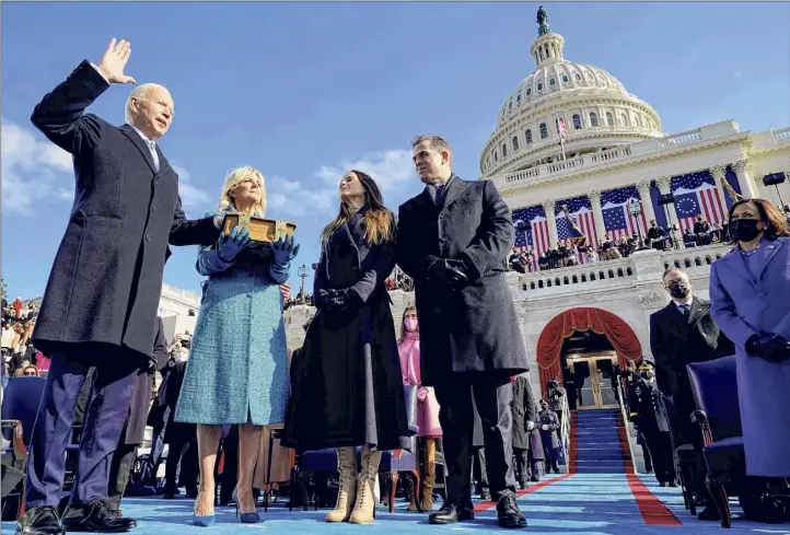  ?? Andrew Harnik / Getty Images ?? Joe Biden, left, is sworn in as the 46th U.S. president on Wednesday at the Capitol in Washington. With the new president are his wife, Jill, his daughter Ashley and his son Hunter. At right is Vice President Kamala Harris.