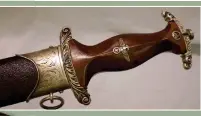  ?? ?? Optional decorative engraved cross-guards were used for very special presentati­ons on the NSKK Honour Dagger (warrelics.eu)