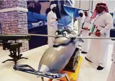  ?? Abdul Rahman./Gulf News ?? The visitors and officials look at the Burkan Precision Guided air Bomb on a display at the Sudan pavilion.