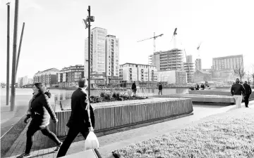  ??  ?? Constructi­on sites and constructi­on cranes work on new developmen­ts at the Quays in Dublin. — AFP photo