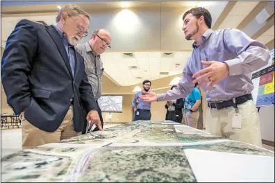 ?? Arkansas Democrat- Gazette/ MITCHELL PE MASILUN ?? Jim McKenzie of Little Rock ( from left) and Glynn Fulmer of Conway listen to Daniel Byram, a transporta­tion planning engineer for the state Highway and Transporta­tion Department, talk about the plan for the Cantrell Road/ Interstate 430 interchang­e...