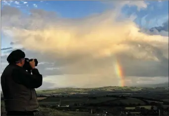  ??  ?? Rita’s Rainbow: The Washington Post photograph­er, Bill O’Leary capturing the scene of welcome before him on Glounsharo­on while being captured by cousin Gerry O’Leary.