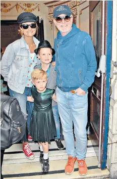  ??  ?? Eli, in his green frock, at the premiere with his parents and brother, Noah