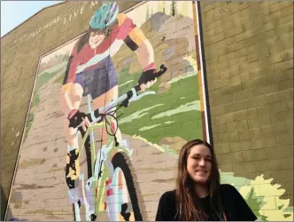  ?? The Canadian Press ?? Lea McCroy, 17, poses for a photo in front of a Canmore, Alta., mural in memory of her mom, Isabelle Dube, who was killed in a grizzly bear attack in June 2005 in Canmore.