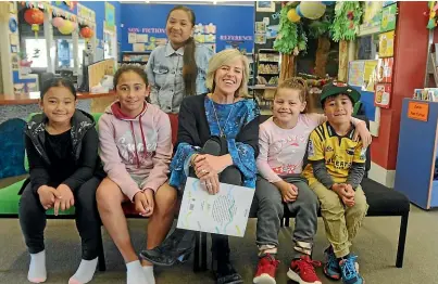  ??  ?? Pomare School principal Cilla Scott loves her job. The students, from left, are Lucien Cherry, Payton Wilkie, Dana Zhaye Lota, Te Arangi Brightwell and Seulata Masoe.