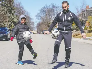  ?? JOHN MAHONEY ?? Gabriele De Fazio, 9, and his father Joe dribble soccer balls outside their home in Lachine. The two came up with online soccer challenges for their teammates to relieve the boredom of staying indoors.