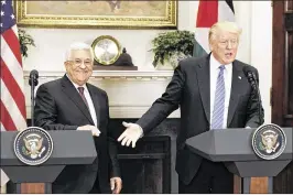  ?? OLIVIER DOULIERY / POOL / GETTY IMAGES ?? President Donald Trump and Palestinia­n Authority President Mahmoud Abbas give a joint statement Wednesday at the White House after meeting to discuss the stalled peace process in the Middle East.