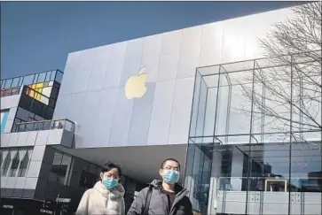  ?? Nicolas Asfouri AFP via Getty Images ?? APPLE has been hurt by factory and store closures in China because of the outbreak. It has reopened about 30 of its 42 stores in China, and suppliers and mass assembly partners are slowly coming back up to speed.