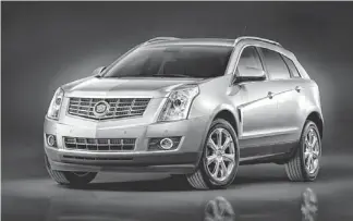  ?? PHOTOS BY GM ?? According to one analyst, Cadillac has done a great job differenti­ating the 2014 Cadillac SRX crossover and the Escalade. GM now needs to work on a small crossover SUV.