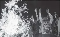  ?? RYAN DORGAN/THE NEW YORK TIMES ?? Kanye West dances around the bonfire at his album listening party Thursday in Moran, Wyo.