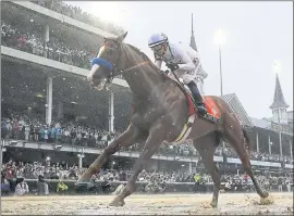  ?? MORRY GASH — THE ASSOCIATED PRESS ?? Mike Smith rides favorite Justify to a historic win on a muddy track in the Kentucky Derby.