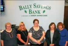  ?? MARTHA GEHRINGER — FOR DIGITAL FIRST MEDIA ?? Diane McElwee and staff stand in front of a new sign that officially marks the merger between Bally Savings and Ambler Savings Bank. The merger allows Bally to offer its clients more financial options.