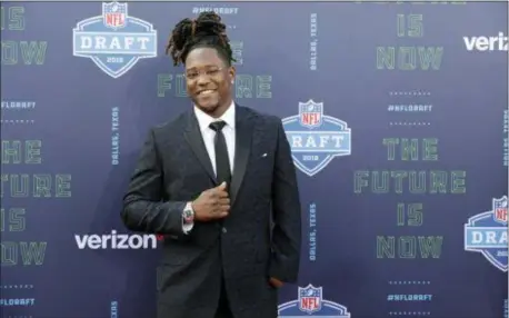  ?? ERIC GAY — THE ASSOCIATED PRESS ?? Central Florida’s Shaquem Griffin poses for photos on the red carpet before the first round of the NFL football draft, Thursday in Arlington, Texas. Griffin waited until Saturday to hear his name called when he was selected by Seattle in the fifth round.