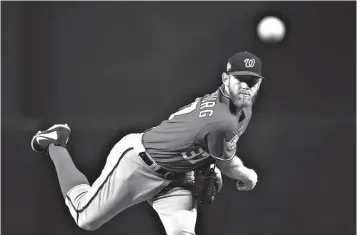  ?? Associated Press ?? ■ Washington Nationals starting pitcher Stephen Strasburg warms up during the first inning of a baseball game against the Arizona Diamondbac­ks on Saturday in Phoenix.