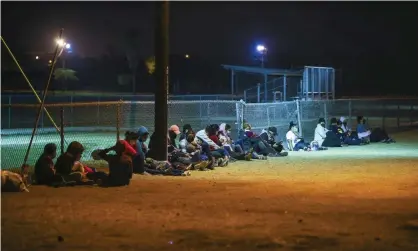  ??  ?? Migrants wait at the border after crossing the Rio Grande. White House spokeswoma­n Jen Psaki said ‘the objective is to make it more difficult to make the journey’. Photograph: Anadolu Agency/Getty Images