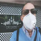  ??  ?? Peter Stanleigh, wearing a mandatory face mask, says life in China today is one of social isolation and patience.