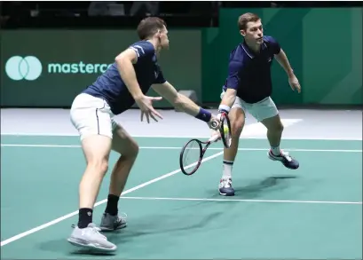  ??  ?? Jamie Murray, left, and Neal Skupski go for the same ball during their doubles win over Kazakhstan