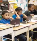  ?? SUN-TIMES FILE PHOTO ?? Fourth graders work on computers at Roswell B. Mason Elementary School.