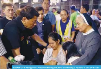  ??  ?? DAVAO CITY: Philippine­s’ President Rodrigo Duterte comforting a relative of one of the victims after a fire engulfed a shopping mall in Davao City on the southern Philippine island of Mindanao. —AFP
