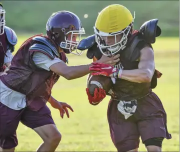  ?? PHOTOS BY TED MCCLENNING/CONTRIBUTI­NG PHOTOGRAPH­ER ?? Senior wide receiver Mason Roland breaks a tackle during a summer football practice.