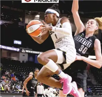  ?? GETTY IMAGES ?? The Sky’s Diamond DeShields, who had 16 points, drives around Storm star Breanna Stewart.