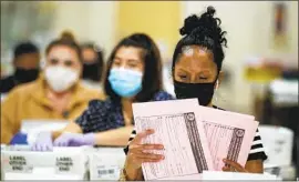  ?? Irfan Khan Los Angeles Times ?? ELECTION WORKER Phyliss Greer sorts recall ballots on Sept. 15 at Fairplex in Pomona. One reform idea: Raise the threshold of voter signatures needed.