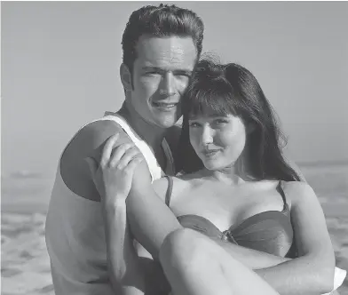  ?? FOX FILES ?? Luke Perry with co-star Shannen Doherty in Beverly Hills 90210: “He’s all devil-may-care attitude and bad-boy flirt. If you’re thirtysome­thing he’s charming and fun. If you’re 15, he drives you nuts,” a reporter wrote at the time.