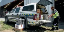  ?? PHOTO: JEFFREY KITT/STUFF ?? Civil Defence emergency response team member Adam Alexander unloads food and mail for a helicopter delivery to communitie­s north of the slips in the days following last year’s quake.