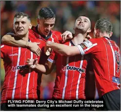  ?? ?? FLYING FORM: Derry City’s Michael Duffy celebrates with teammates during an excellent run in the league