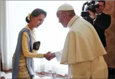  ??  ?? In this May 4 file photo, Myanmar leader Aung San Suu Kyi (left), is welcomed by Pope Francis at the Vatican. TONY GENTILE/POOL PHOTO VIA AP