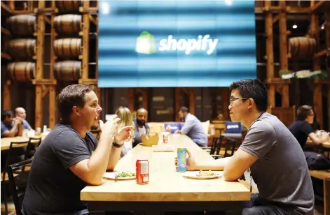  ?? COLE BURSTON/BLOOMBERG ?? Employees eat in a common area at the Shopify Inc. office in Waterloo. The Canadian company holds no issued patents, which may demonstrat­e why simply counting patents is a massive oversimpli­fication when it comes to quantifyin­g innovation in the economy.