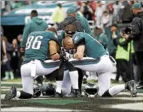  ?? MICHAEL PEREZ — THE ASSOCIATED PRESS ?? Philadelph­ia Eagles’ Zach Ertz (86), Carson Wentz (11), and Trey Burton (88) pray ahead of their game against the San Francisco 49ers in Philadelph­ia earlier this season.