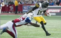  ?? GRAHAM HUGHES, THE CANADIAN PRESS ?? Brandon Banks breaks away from Oumar Toure during Sunday’s 43-16 victory over the Alouettes in Montreal.