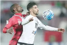  ?? — AFP ?? UAE’s Al-Jazira player Boussoufa Mbark (right) fights for the ball with Qatar’s Lekhwiya player Mohammed Tresor during the Asian Champions League match between Lekhwiya SC and Al-Jazira Club at Abdullah bin Khalifa Stadium in Doha on Monday.