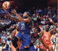  ?? Sean D. Elliot / Associated Press ?? Minnesota Lynx guard Seimone Augustus (33) uses a screen from teammate Sylvia Fowles (34) to get a clear drive to the basket against the Connecticu­t Sun during the first half of a WNBA game in Uncasville in 2018. Augustus has retired from playing and will be an assistant coach for the Los Angeles Sparks, the team announced on Thursday.